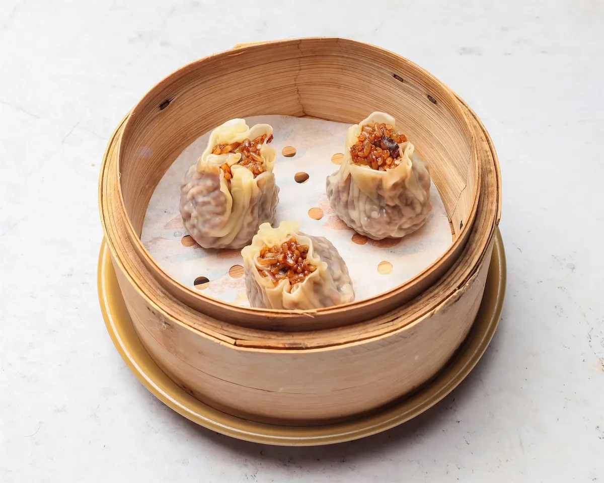 House-made Shanghai Siu Mai served in a bamboo steamer at Bamboo Basket, Chinese restaurant Victoria London